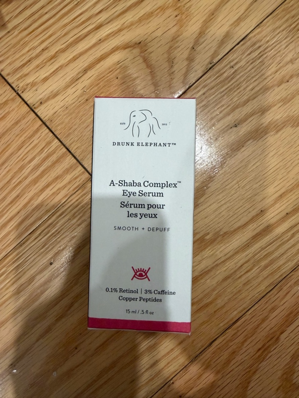Drunk Elephant Eye Serum Box in White with Pink Accents